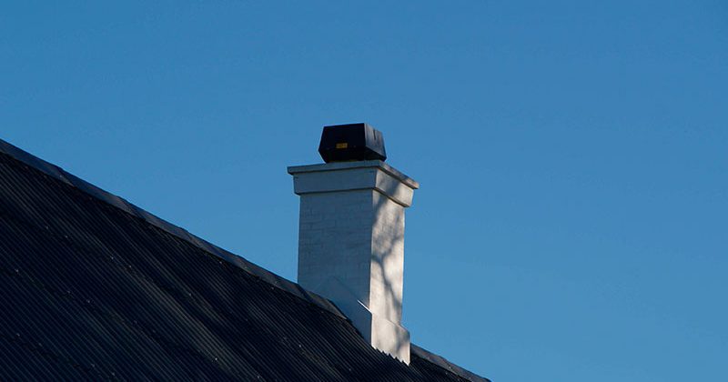 chimney fan on a white chimney
